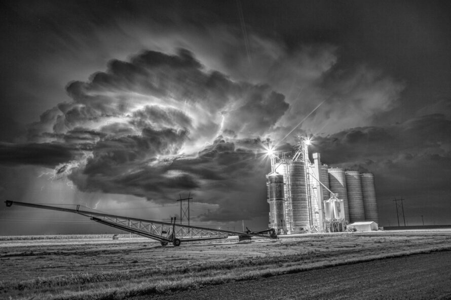 Lightning illuminates the updraft of a thunderstorm near the Rock Island Elevator in Grant County Kansas