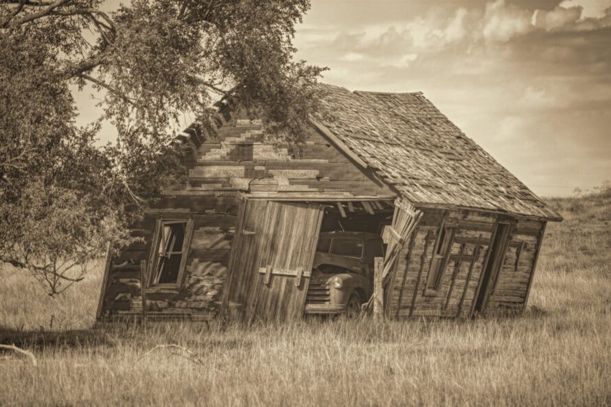 A old truck is forgotten in an abandoned garage in Kearny County Kansas